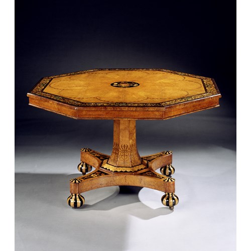 A VICTORIAN INLAID AMBOYNA CENTRE TABLE